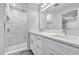 Elegant bathroom featuring double vanity sinks and a marble tiled walk-in shower at 4314 Se 131St Ln, Belleview, FL 34420