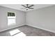 Bright bedroom with gray tile flooring and a ceiling fan at 4314 Se 131St Ln, Belleview, FL 34420