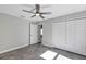 Bedroom featuring gray walls, floors, ceiling fan and closet at 4314 Se 131St Ln, Belleview, FL 34420