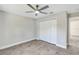 Clean bedroom with spacious closet, neutral walls, updated floors and ceiling fan at 4314 Se 131St Ln, Belleview, FL 34420