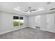 Bedroom with a tray ceiling, a ceiling fan, and a view to the exterior at 4314 Se 131St Ln, Belleview, FL 34420