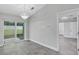 Dining room area with sliders to the exterior and a view into the bathroom at 4314 Se 131St Ln, Belleview, FL 34420