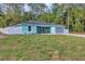 Charming single-story home features a manicured lawn, gray roof, light blue exterior, attached two car garage and white fencing at 4314 Se 131St Ln, Belleview, FL 34420