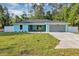 Charming single-story home boasts a manicured lawn, gray roof, an attached two car garage, and a light blue exterior at 4314 Se 131St Ln, Belleview, FL 34420