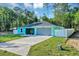 Beautiful single-Gathering home featuring a lovely lawn, long driveway, blue exterior, and fenced yard at 4314 Se 131St Ln, Belleview, FL 34420