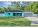 This lovely home boasts a gray garage door, a blue exterior, and a beautifully landscaped front yard at 4314 Se 131St Ln, Belleview, FL 34420