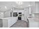 Open kitchen with quartz counters, stainless appliances, white cabinets, and large island at 4314 Se 131St Ln, Belleview, FL 34420