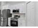 Kitchen with stainless steel appliances, quartz countertops, and white cabinetry at 4314 Se 131St Ln, Belleview, FL 34420