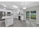 Spacious kitchen with stainless steel appliances, white cabinets, and sliding glass doors at 4314 Se 131St Ln, Belleview, FL 34420