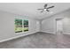 Bright living area features a fan, gray tile flooring, white door and trim, with a window view at 4314 Se 131St Ln, Belleview, FL 34420