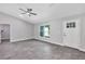 Bright living area with gray tile flooring, crisp white trim, neutral walls, and a fan at 4314 Se 131St Ln, Belleview, FL 34420