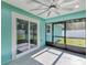 Enclosed patio with sliding door and ceiling fan, leading to fenced backyard at 4314 Se 131St Ln, Belleview, FL 34420