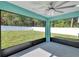 Screened-in patio overlooking the backyard, with a ceiling fan for added comfort at 4314 Se 131St Ln, Belleview, FL 34420