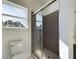 Bathroom showing a modern, tiled shower with a glass door and bright window at 4415 Sw 169Th Lane Rd, Ocala, FL 34473