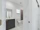 Modern bathroom featuring marble floors, sleek vanity, and well lit mirror at 4415 Sw 169Th Lane Rd, Ocala, FL 34473
