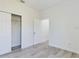 Bedroom with neutral walls and wood-look flooring, plus walk-in closet with sliding doors at 4415 Sw 169Th Lane Rd, Ocala, FL 34473