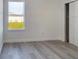 Bright bedroom offers durable flooring, window view, and adjacent closet at 4415 Sw 169Th Lane Rd, Ocala, FL 34473