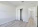 Comfortable bedroom featuring light-colored flooring, spacious closet, and hallway access at 4415 Sw 169Th Lane Rd, Ocala, FL 34473