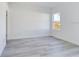 Bright bedroom with wood-look flooring and a window overlooking a grassy area at 4415 Sw 169Th Lane Rd, Ocala, FL 34473