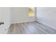 Bright bedroom featuring durable, light-colored flooring and a sunlit window at 4415 Sw 169Th Lane Rd, Ocala, FL 34473