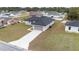 Aerial front view of a single-story home featuring a two-car garage and a long driveway at 4415 Sw 169Th Lane Rd, Ocala, FL 34473
