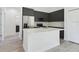Stylish kitchen showcasing dark cabinets, quartz countertops, stainless steel appliances, and an island at 4415 Sw 169Th Lane Rd, Ocala, FL 34473