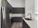 Modern kitchen with stainless steel appliances, dark cabinetry, light countertops, and a large island sink at 4415 Sw 169Th Lane Rd, Ocala, FL 34473