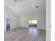 Spacious living room with vaulted ceilings, recessed lighting, and sliding glass doors to the backyard at 4415 Sw 169Th Lane Rd, Ocala, FL 34473