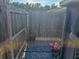 Backyard space featuring a wooden fence, planters, and stone tile, creating a secluded area for plants and decor at 5024 Se 107Th Pl, Belleview, FL 34420