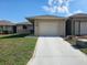 Charming single-story home with a well-manicured lawn and a one car garage at 5024 Se 107Th Pl, Belleview, FL 34420