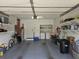 Spacious garage with ample storage shelving, providing plenty of room for parking and organizing tools and equipment at 5024 Se 107Th Pl, Belleview, FL 34420