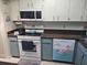 Well-equipped kitchen featuring modern appliances, stylish cabinetry, and plenty of countertop workspace at 5024 Se 107Th Pl, Belleview, FL 34420