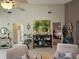 Bright living room showcasing high ceilings, decorative art, and cozy seating area with view to the main bedroom at 5024 Se 107Th Pl, Belleview, FL 34420