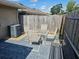 Outdoor patio area with a table and chairs, bench seating, and a privacy fence at 5024 Se 107Th Pl, Belleview, FL 34420