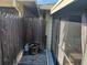 Cozy patio area featuring a wooden fence, a small propane tank and a potted plant for added privacy at 5024 Se 107Th Pl, Belleview, FL 34420