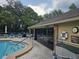 Community swimming pool and pool house with lounge chairs, perfect for outdoor relaxation at 5024 Se 107Th Pl, Belleview, FL 34420