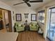 Inviting sitting area with cozy green chairs, beach themed decor, and ample natural light, ideal for relaxation at 5024 Se 107Th Pl, Belleview, FL 34420