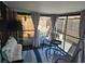 Enclosed sunroom with comfortable seating, stylish decor, and sliding glass doors to a fenced yard at 5024 Se 107Th Pl, Belleview, FL 34420