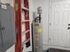 This utility room features a water heater, an electrical panel, and a ladder for easy access to home maintenance at 5024 Se 107Th Pl, Belleview, FL 34420