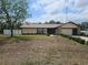 A charming single-story home with a two-car garage, stone accents, and a well-manicured lawn at 516 Marion Oaks Dr, Ocala, FL 34473