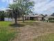 A quaint single-Gathering home with a beige facade, stone accents, and a well-kept lawn at 516 Marion Oaks Dr, Ocala, FL 34473
