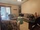 Living room with sliding glass door, tiled floors, ceiling fan, and comfortable seating at 516 Marion Oaks Dr, Ocala, FL 34473