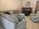 Living room with a corner sofa, piano, and tiled floors at 516 Marion Oaks Dr, Ocala, FL 34473