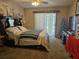 The main bedroom has a sliding glass door and an en suite at 516 Marion Oaks Dr, Ocala, FL 34473