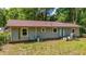 Rear exterior of the home with a partial view of the backyard area at 5737 Nw 65Th Pl, Ocala, FL 34482