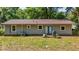 View of the rear exterior with a small deck and outdoor space at 5737 Nw 65Th Pl, Ocala, FL 34482