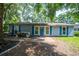 Charming single-story home with blue shutters, brick walkway, and mature trees in a peaceful setting at 5737 Nw 65Th Pl, Ocala, FL 34482