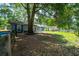 Cozy single-story home with blue shutters situated on a spacious lot with mature trees and partial fencing at 5737 Nw 65Th Pl, Ocala, FL 34482