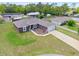 An aerial of the property featuring a well-maintained single-story home with a lawn, driveway, and a two-car garage at 60 Hemlock Trl, Ocala, FL 34472