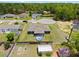 Aerial view of the home's backyard with a small pool, shed, surrounded by fencing and a lush tree line at 60 Hemlock Trl, Ocala, FL 34472